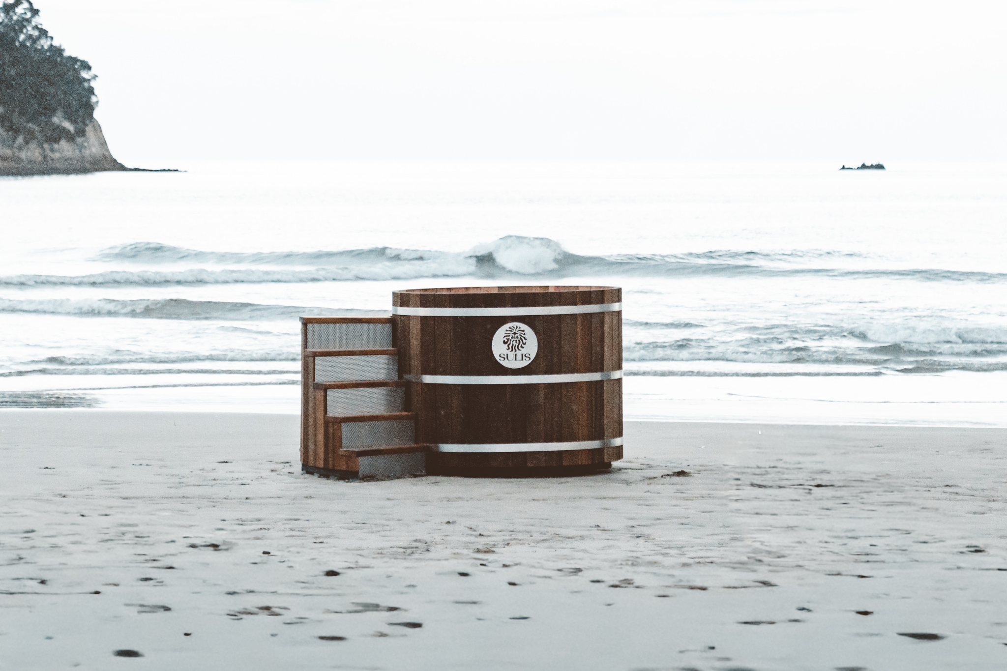 Wooden Sulis Hot Tub on a snowy beach with a blurred background