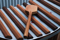 A brown wooden hot tub cover, known as a Sulis Sail Lid, is shown partially open with a wooden handle.