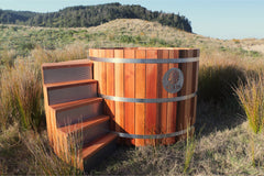 Wooden Cedar Sulis hot tub with steps in a natural outdoor setting